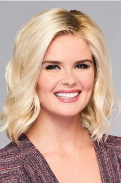 Woman in a shoulder length blonde wig with choppy layers