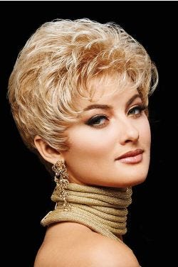 Woman in a petite curly light brown pixie wig with longer layers on the top and back