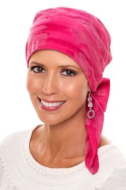 Woman in pink cotton tie dyed head wrap for women with cancer