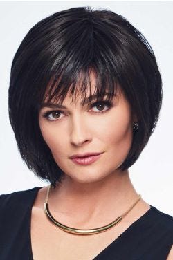 Woman in a past the chin length black blunt bob wig with fringe bangs