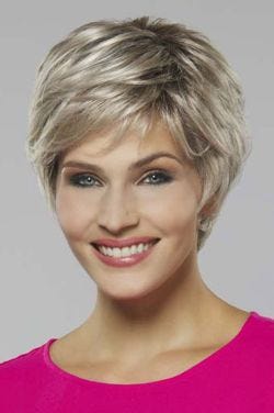 Woman in a platinum blonde long pixie wig with side bangs