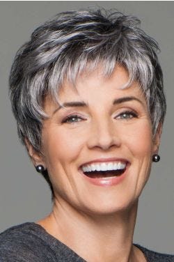 Happy woman in a classic grey pixie wig with shaggy textured bangs