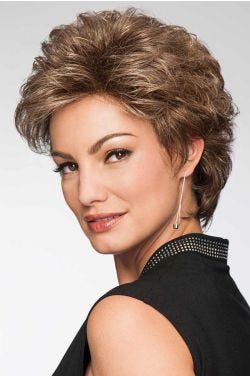 Woman in a semi-long medium brown curly pixie wig
