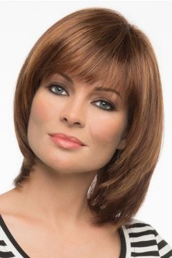 Woman in a shoulder length light auburn blunt bob wig with shorter layers along the face and fringe bangs