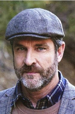 Cool older man in grey tweed wool driver cap or flat hat
