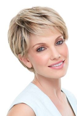 Woman in a blonde classic pixie style wig with feathered bangs and darker layers