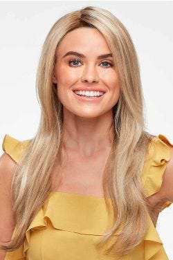 Woman in an extra long semi-wavy medium blonde lace front wig
