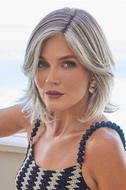 Woman in a shoulder length grey long layered lace front bob wig with side bangs