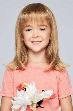 Little girl in a past the shoulders straight blonde wig with bangs