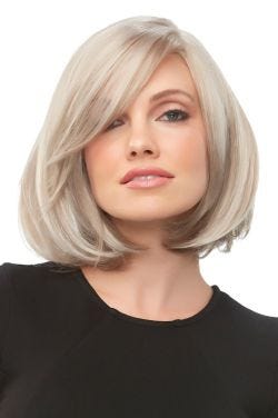 Woman in a chin length platinum blonde blunt bob wig with long side bangs