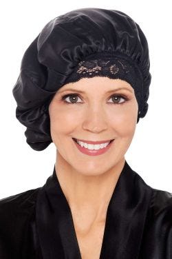 Woman in black silk sleep bonnet sleeping cap with lace trim for cancer patients