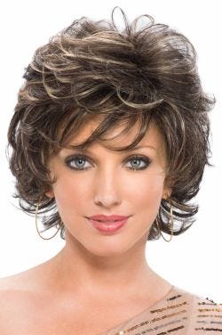 Woman in a short curly dark brown wig with wispy bangs