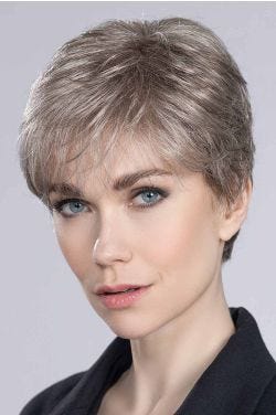 Woman in a cropped platinum blonde pixie wig