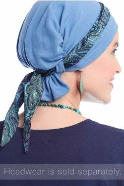 Woman in blue head covering featuring mini scarf that can be tied onto multiple hats turbans and scarves to accessorize them