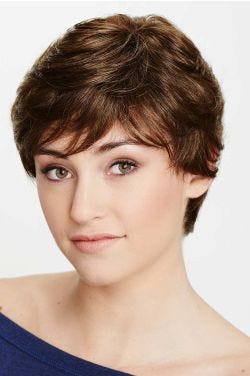 Woman in a medium brown pixie wig with fringe bangs