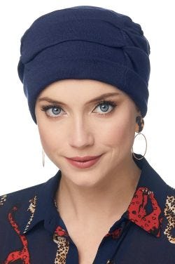 Woman in blue pleated organic cotton turban for women with cancer
