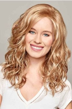 Woman in a past the shoulders curly light auburn lace front wig