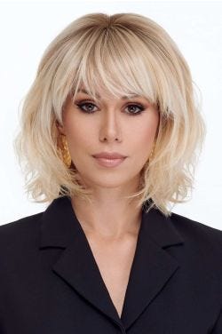 Woman in a shoulder length light blonde curly lace front wig with fringe bangs
