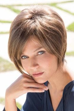 Woman in longer short brown wig with long layers to the chin