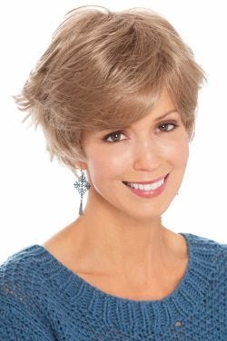 Woman in sassy, flippy, layered short blonde wig with bangs