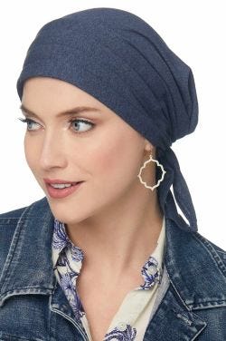 Woman in dark blue denim organic cotton pre tied head scarf for cancer patients