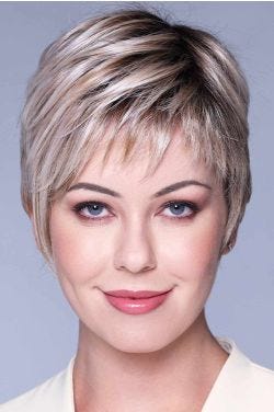 Woman in an ash blonde lace front pixie wig with choppy bangs and longer side layers