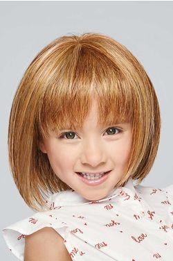 Little girl in a shoulder length light auburn bob children's wig with bangs