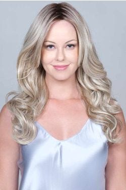 Woman in an extra long medium blonde curly lace front wig