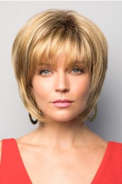Woman in blonde short chin length bob wig with layers and bangs