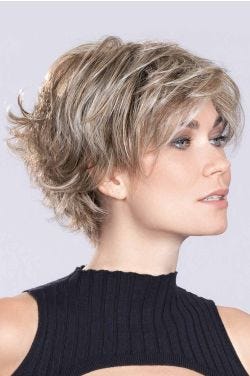 Woman in a large short shaggy asymmetric light blonde lace front bob wig with wispy bangs