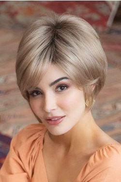 Woman in a chin length light blonde stacked bob wig
