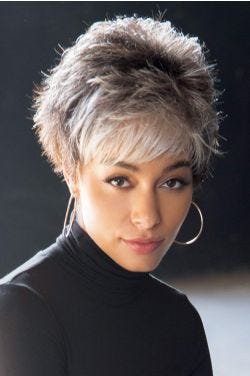 Woman in short spiky grey wig with layers and bangs