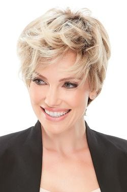 Woman in a tousled light blonde pixie wig with choppy long layers