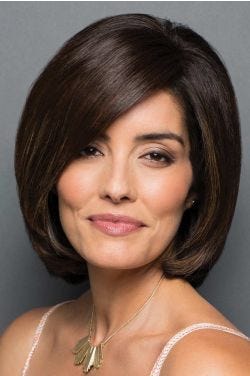 Woman with long face framing dark brown bangs attached to her biological hair