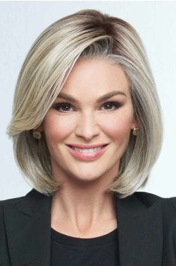 Woman in a chin length light blonde lace front bob wig with long side bangs