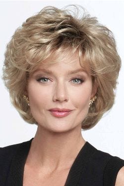 Woman in large dark blonde cropped shag wig with full curly layers and textured bangs