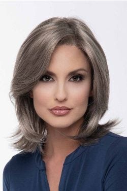 Woman in a shoulder length grey lace front wig with long layers