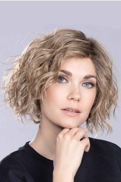 Woman in a chin length wavy light brown lace front wig