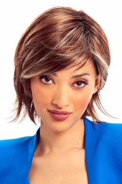 Woman in a past the chin layered warm brown bob wig with side bangs