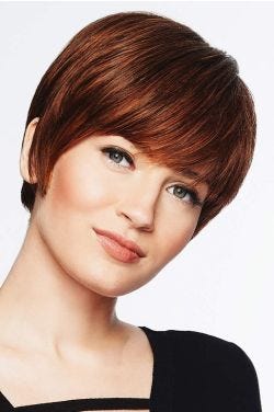Woman in a long layered medium auburn pixie wig with fringe bangs