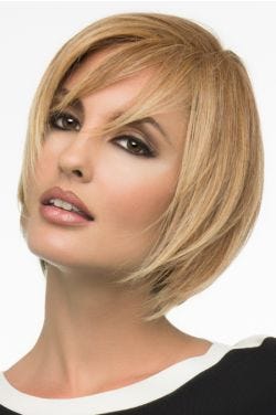 Woman in a chin length warm blonde bob wig with wispy side bangs