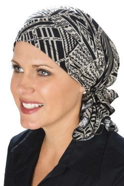 Woman in pre tied head scarf for cancer patients in black and beige print
