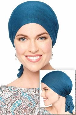 Woman in teal pre tied head scarf for cancer patients