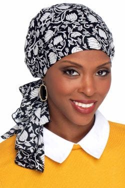 Woman in black cotton floral pre tied head scarf for cancer patients