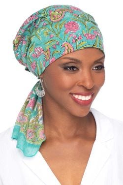 Women in teal floral pre tied cotton head scarf for women with cancer