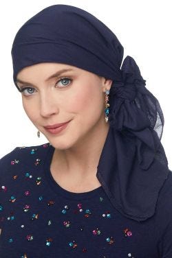 Woman in navy blue head scarf tied into a bow for women