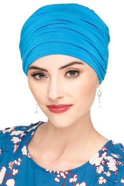 Woman in blue bamboo chemo turban with fabric layers for body on the head