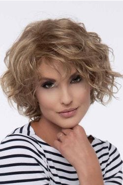 Woman in a chin length curly dark blonde layered bob wig