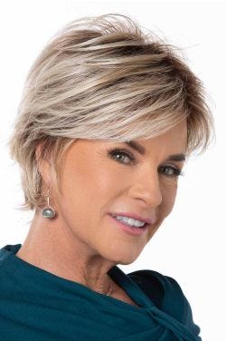 Woman in a light blonde long pixie wig with side bangs