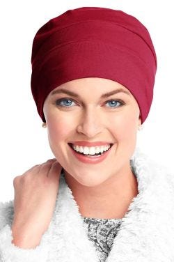 Woman in pink organic cotton beanie style sleeping cap with three seams for chemo